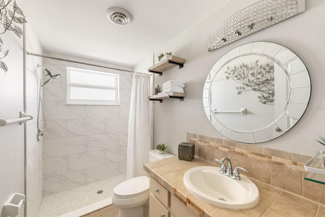 bathroom with toilet, vanity, visible vents, a shower stall, and decorative backsplash