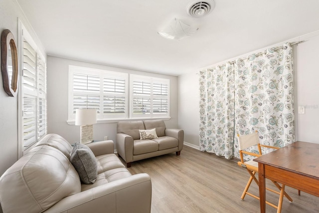 living room featuring light wood-type flooring and visible vents