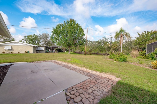 view of yard with a wall unit AC and a patio