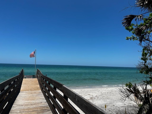 surrounding community featuring a water view and a view of the beach