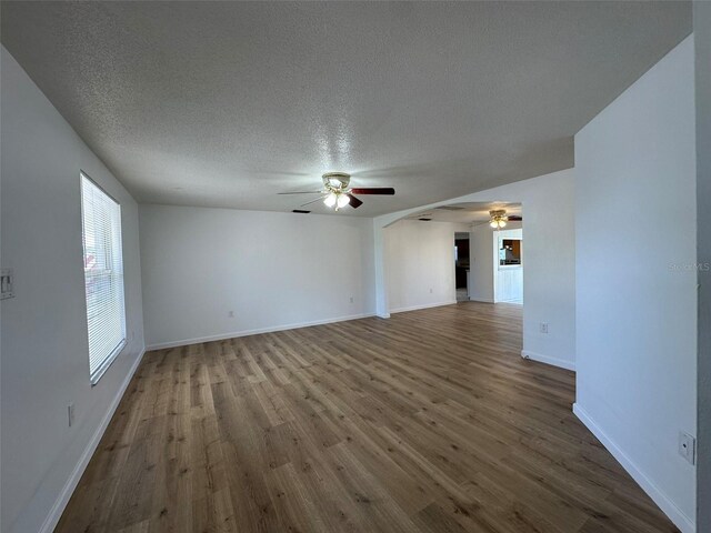 192 Garden Ave NW, Port Charlotte, FL 33952 - spare room with dark wood-style floors, a ceiling fan, baseboards, and a textured ceiling