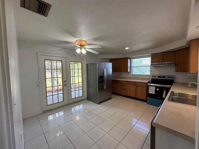 192 Garden Ave NW, Port Charlotte, FL 33952 - kitchen with under cabinet range hood, stainless steel appliances, a sink, visible vents, and french doors