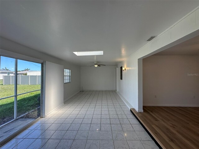 192 Garden Ave NW, Port Charlotte, FL 33952 - empty room with a ceiling fan, a skylight, visible vents, and baseboards