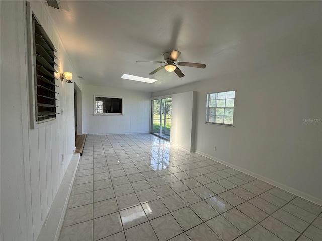 192 Garden Ave NW, Port Charlotte, FL 33952 - unfurnished room with a skylight, visible vents, baseboards, ceiling fan, and light tile patterned flooring