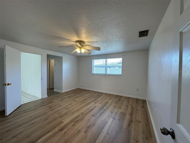 192 Garden Ave NW, Port Charlotte, FL 33952 - interior space featuring a textured ceiling, wood finished floors, visible vents, and baseboards