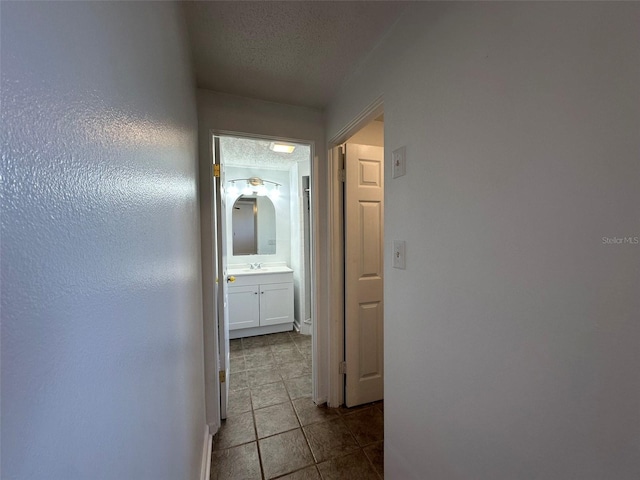 192 Garden Ave NW, Port Charlotte, FL 33952 - hall with a sink, a textured ceiling, and tile patterned floors