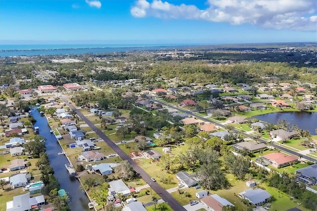 birds eye view of property featuring a water view and a residential view