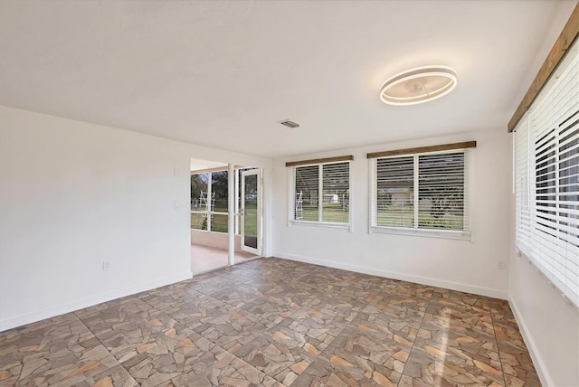 interior space featuring baseboards and stone finish floor