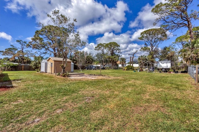 view of yard featuring a storage shed, an outdoor structure, and a fenced backyard