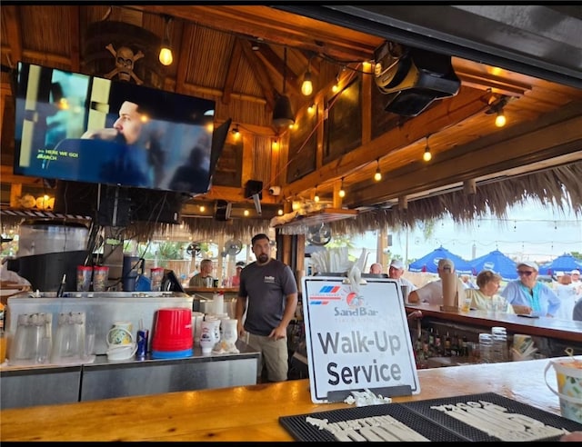 bar featuring high vaulted ceiling