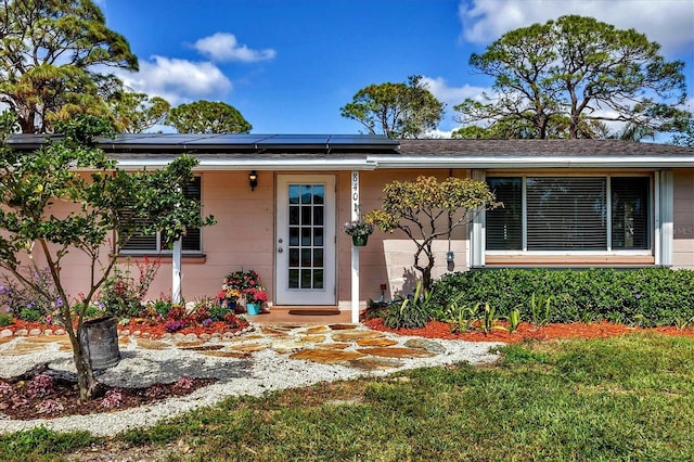 view of front of house featuring roof mounted solar panels