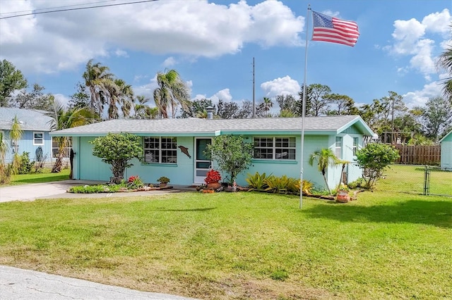 ranch-style home with fence, a front lawn, concrete driveway, and stucco siding