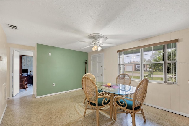 dining space featuring visible vents, ceiling fan, a textured ceiling, and speckled floor