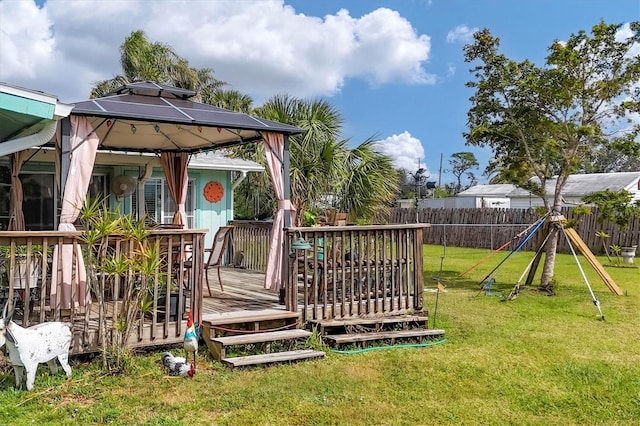 view of yard featuring a gazebo, fence, and a wooden deck