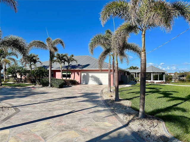 ranch-style house featuring an attached garage, a front lawn, and concrete driveway