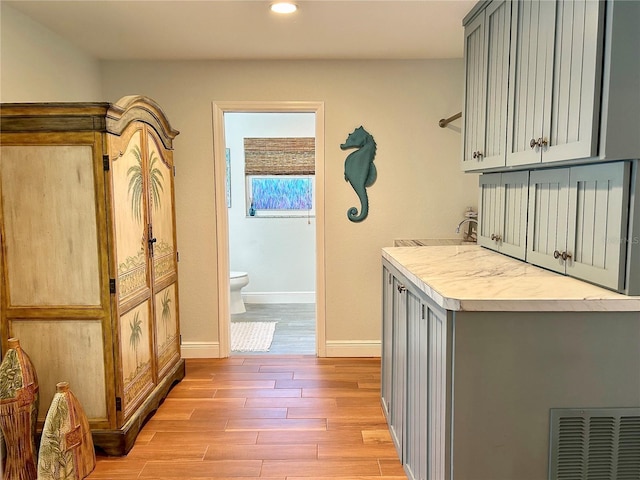 interior space featuring baseboards, recessed lighting, visible vents, and light wood-style floors