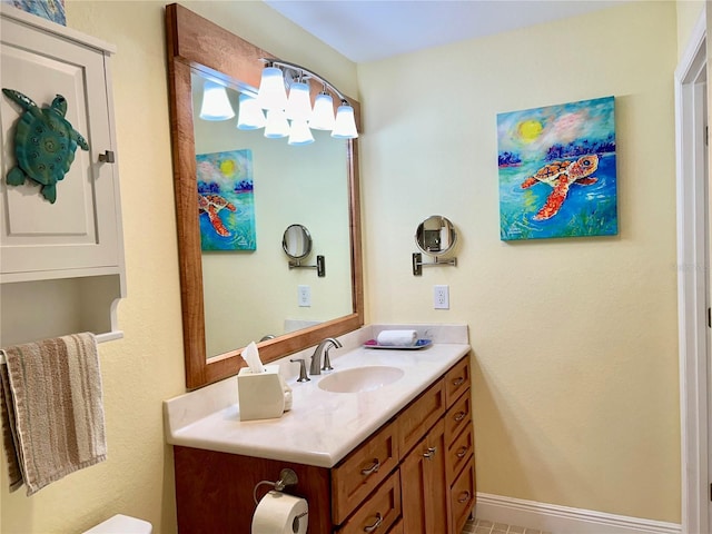 half bathroom with vanity and baseboards