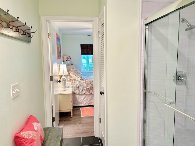 ensuite bathroom featuring tiled shower and ensuite bathroom