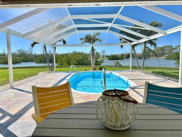 pool with a water view, glass enclosure, and a patio