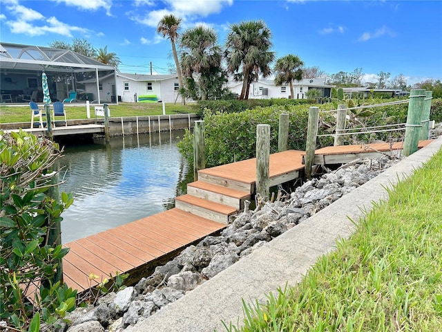 dock area with a water view and a lanai