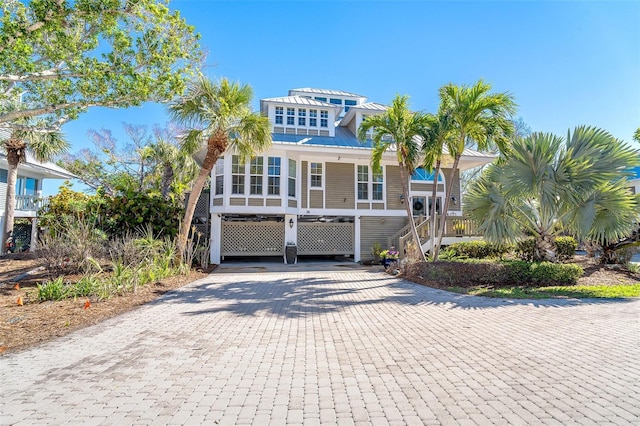 raised beach house with decorative driveway and stairway