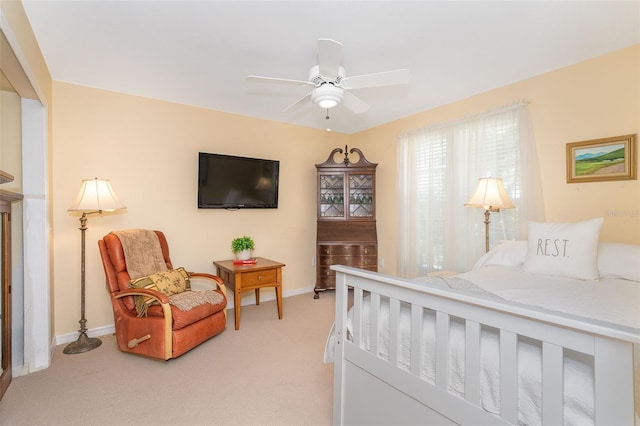 bedroom with baseboards, a ceiling fan, and light colored carpet