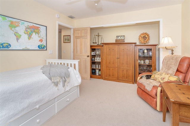 bedroom featuring ceiling fan, visible vents, and light colored carpet