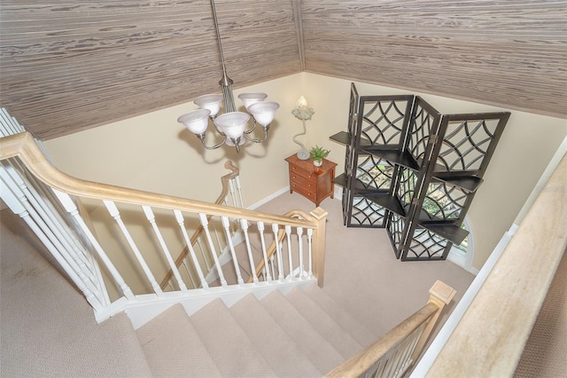 stairway featuring vaulted ceiling, carpet flooring, wood ceiling, and a notable chandelier