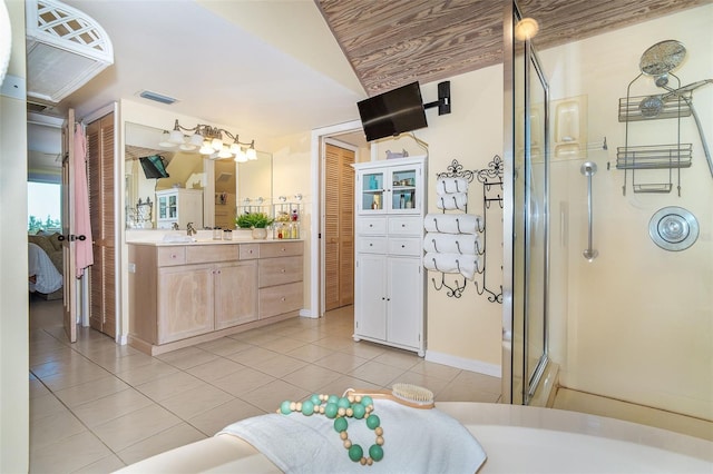 ensuite bathroom featuring visible vents, connected bathroom, a shower stall, vanity, and tile patterned floors