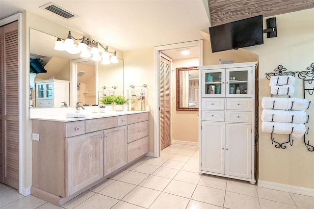 full bath with vanity, visible vents, a closet, and tile patterned floors