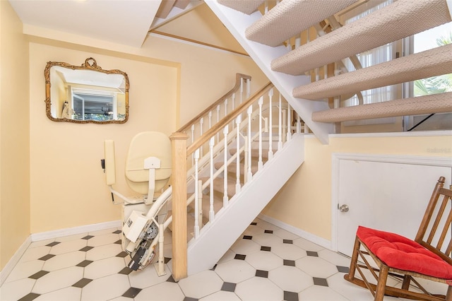 stairway featuring baseboards and tile patterned floors