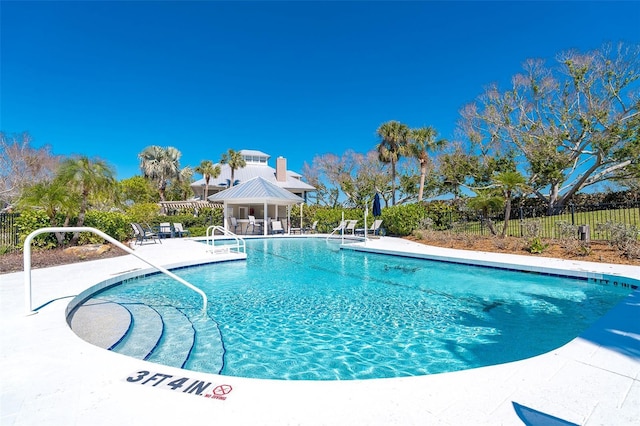 community pool featuring a patio, a gazebo, and fence