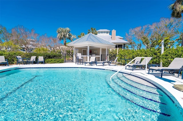 pool featuring a patio area, fence, and a pergola