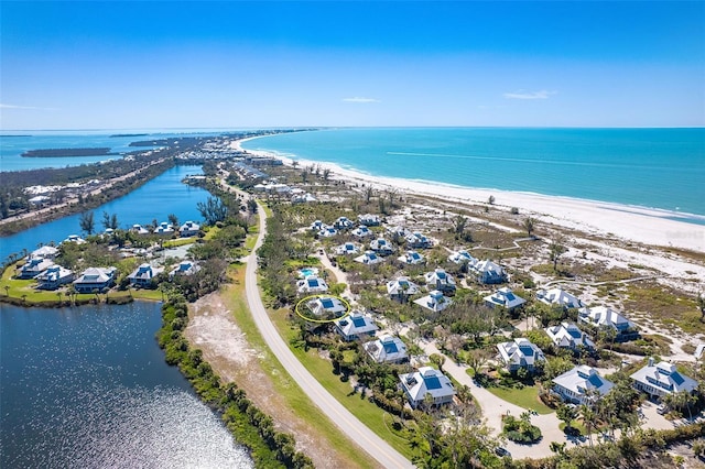 birds eye view of property with a beach view and a water view