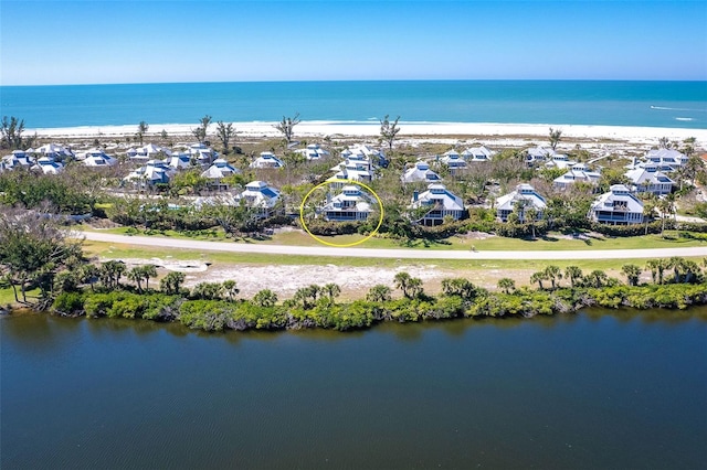 bird's eye view featuring a water view, a residential view, and a beach view