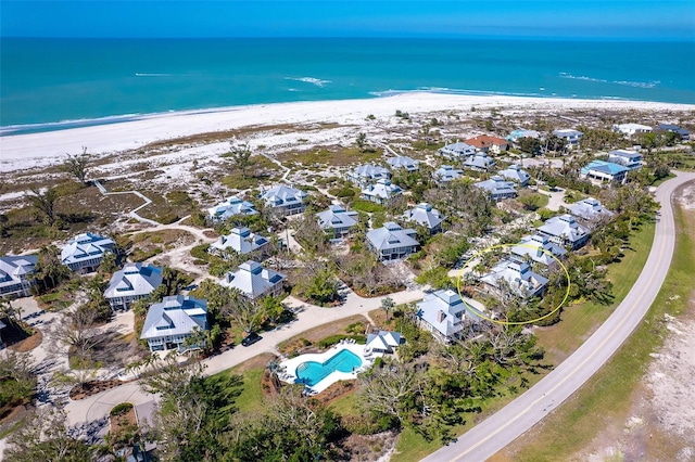 aerial view featuring a residential view, a view of the beach, and a water view