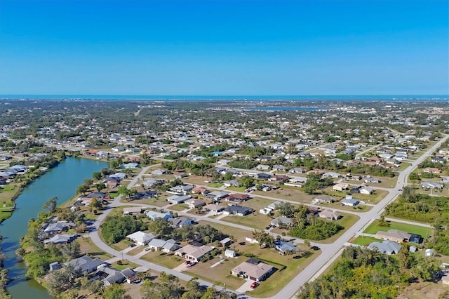 drone / aerial view with a residential view and a water view