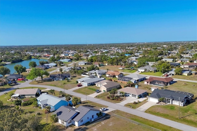 birds eye view of property featuring a residential view and a water view