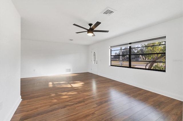 spare room featuring visible vents, baseboards, ceiling fan, and hardwood / wood-style floors