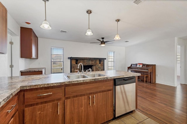 kitchen featuring a healthy amount of sunlight, visible vents, ceiling fan, a sink, and dishwasher