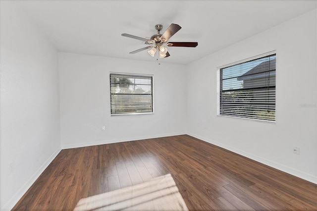 unfurnished room featuring baseboards, a healthy amount of sunlight, wood finished floors, and a ceiling fan