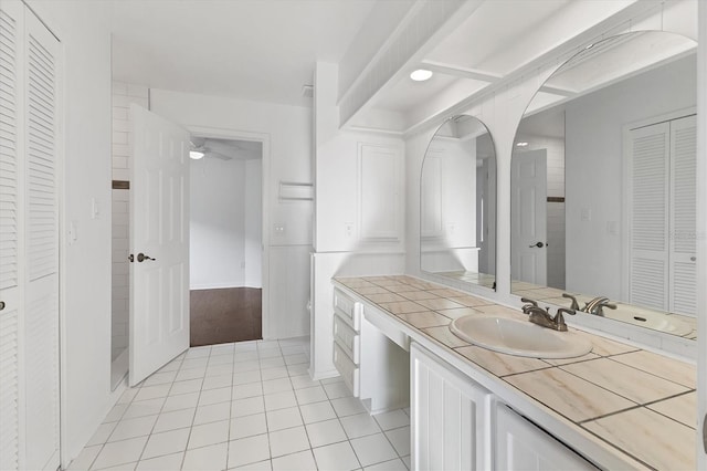 bathroom featuring a closet, vanity, a ceiling fan, and tile patterned flooring