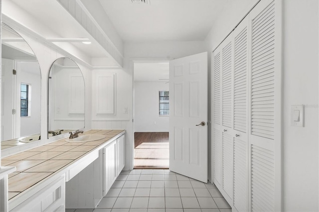 bathroom featuring a closet, visible vents, vanity, and tile patterned flooring