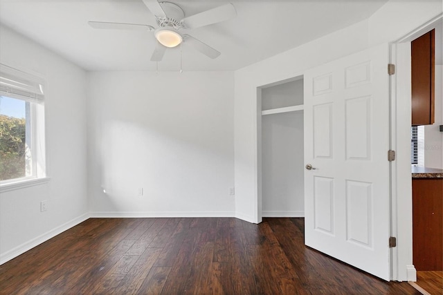 unfurnished bedroom featuring a ceiling fan, wood finished floors, and baseboards