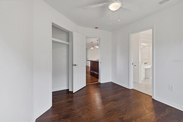 unfurnished bedroom featuring visible vents, a ceiling fan, baseboards, and wood finished floors