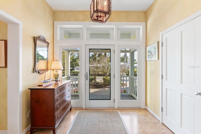 entryway featuring light wood-style floors and baseboards