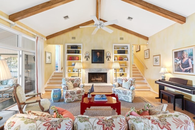 living area with stairway, a fireplace, visible vents, and built in features