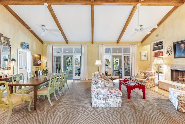 living room featuring ceiling fan, built in shelves, and beam ceiling