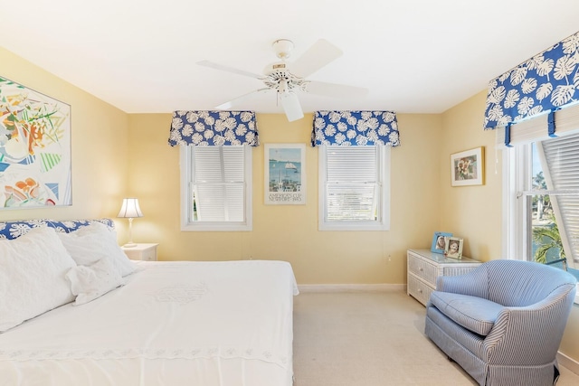 bedroom with ceiling fan, baseboards, and carpet flooring