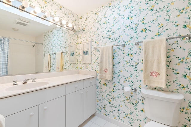 bathroom featuring tile patterned floors, vanity, and wallpapered walls